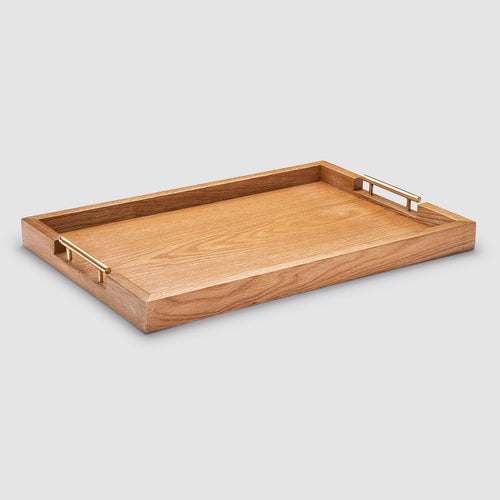 Wooden tray with brass handles on a light gray background