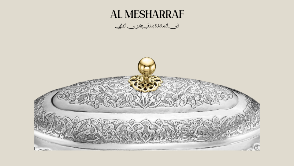 Decorative silver container with gold lid on a beige background, featuring the brand 'Al Mesharraf'.